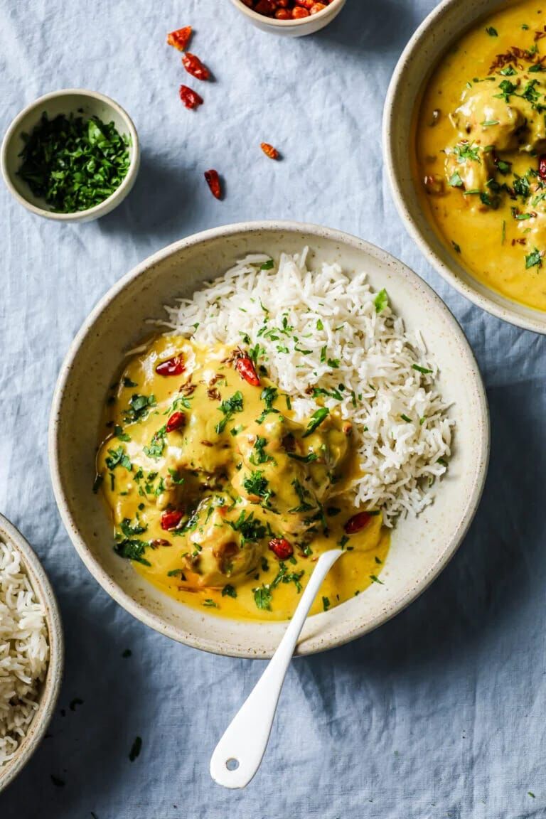 A flavorful and spicy dish consisting of crispy fried pakoda (fritters) served in a rich and creamy curry sauce, accompanied by a side of plain boiled rice. A flavorful and spicy dish consisting of crispy fried pakoda (fritters) served in a rich and creamy curry sauce, accompanied by a side of plain boiled rice.