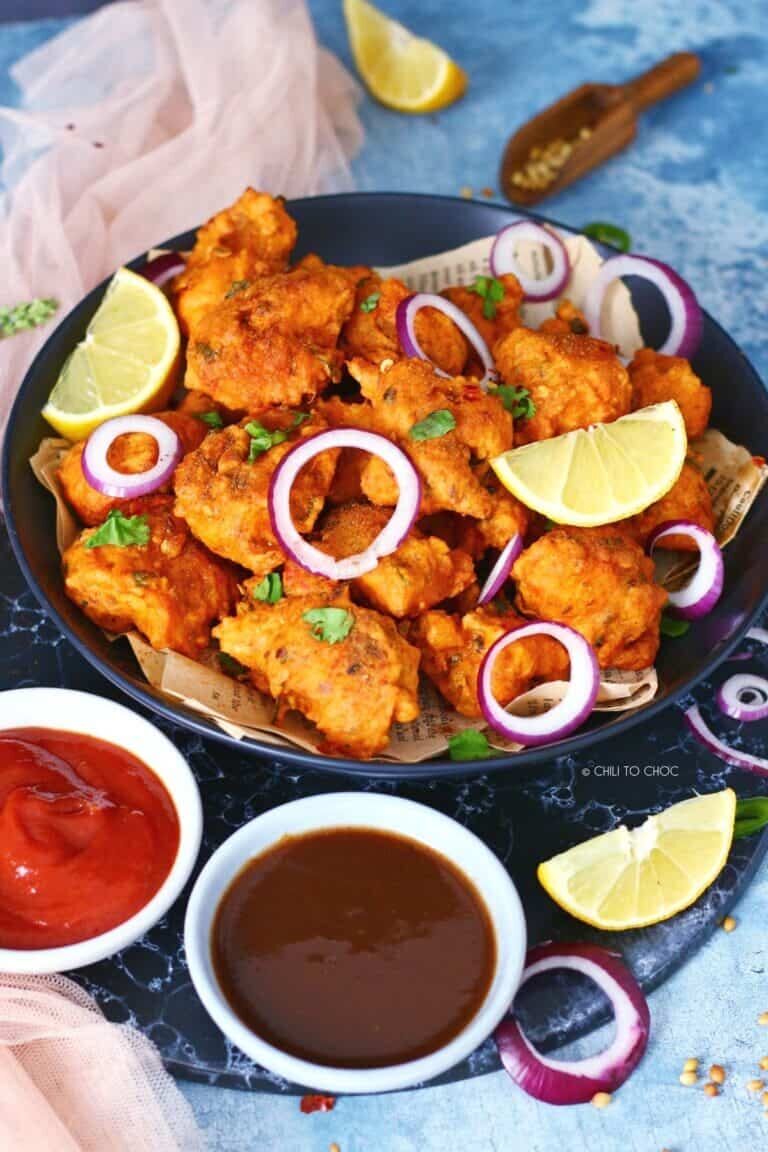 Crispy fried fish pieces coated in a spicy batter, often served as a snack or appetizer. Crispy fried fish pieces coated in a spicy batter, often served as a snack or appetizer.